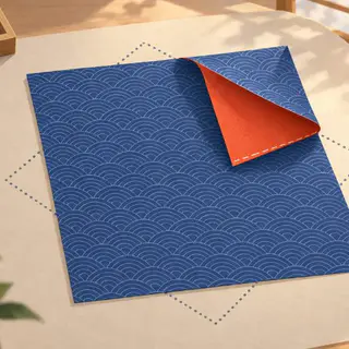 Fold cover art: A square of indigo wave-print origami paper, one corner curling over to show its vermilion back, inside a dotted outline.